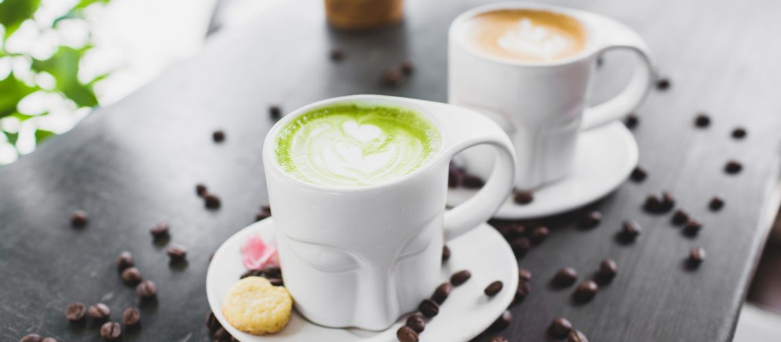 cups-of-cappuccino-and-matcha-tea-served-on-cafe-terrace-4552172